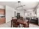 A dining area seamlessly connects the kitchen to the living room with an open concept and double door backyard access at 273 S 152Nd Ave, Goodyear, AZ 85338