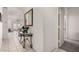 Inviting hallway featuring tiled floors and a decorative mirror and table at 273 S 152Nd Ave, Goodyear, AZ 85338