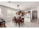 Bright kitchen and dining space with tile floors, stainless steel appliances, and a view of the backyard at 273 S 152Nd Ave, Goodyear, AZ 85338