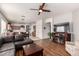 Open-concept living space with hardwood floors, a ceiling fan, a fireplace, and backyard access at 273 S 152Nd Ave, Goodyear, AZ 85338
