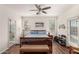 Main bedroom features a ceiling fan, hardwood floors, dual windows, and an en suite bathroom for added comfort at 273 S 152Nd Ave, Goodyear, AZ 85338
