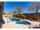 Private backyard oasis featuring a pool, spa, desert landscaping, and privacy walls for outdoor enjoyment at 273 S 152Nd Ave, Goodyear, AZ 85338