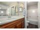 A well-lit bathroom with wood cabinets, white counter, and a shower-tub combo at 2821 S Skyline Dr # 107, Mesa, AZ 85212