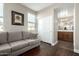 An inviting bedroom featuring gray sofa, dark wood floors and a closet with white, sliding doors at 2821 S Skyline Dr # 107, Mesa, AZ 85212