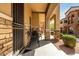 Cozy covered front porch with seating and stylish stone detailing at 2821 S Skyline Dr # 107, Mesa, AZ 85212
