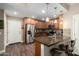 Kitchen with wood cabinetry, stainless appliances, and a breakfast bar at 2821 S Skyline Dr # 107, Mesa, AZ 85212