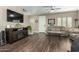 Open-concept living space with wood floors and a cozy entertainment center at 2821 S Skyline Dr # 107, Mesa, AZ 85212