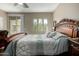 The spacious main bedroom features an ornate headboard and a sliding glass door to the outside patio at 2821 S Skyline Dr # 107, Mesa, AZ 85212