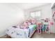 Cozy bedroom with twin bed, playhouse, bright lighting, and tile flooring at 3009 N 81St Ln, Phoenix, AZ 85033
