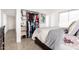 Bedroom featuring a large closet, a comfortable bed, and tile flooring at 3009 N 81St Ln, Phoenix, AZ 85033