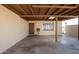 View of the spacious covered carport, featuring a large window and a secure entrance door at 3009 N 81St Ln, Phoenix, AZ 85033