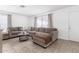 Inviting living room with plush seating, tile floors, and natural light at 3009 N 81St Ln, Phoenix, AZ 85033