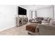 Stylish living room with a large TV, comfortable seating, and modern furnishings at 3009 N 81St Ln, Phoenix, AZ 85033