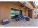 Inviting covered patio with outdoor seating and an extended view of the backyard and pool at 3816 E Rakestraw Ln, Gilbert, AZ 85298
