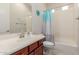 Bright bathroom featuring a single sink vanity, toilet, shower and tub combination, and natural light at 3816 E Rakestraw Ln, Gilbert, AZ 85298