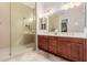 Luxurious bathroom featuring glass enclosed shower, dual sink vanity, and neutral colors at 3816 E Rakestraw Ln, Gilbert, AZ 85298