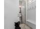 Hallway leading to a powder room with neutral walls, white wainscotting, and pedestal sink at 3816 E Rakestraw Ln, Gilbert, AZ 85298