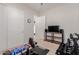 Neutral-toned bedroom featuring exercise equipment, television, and a ceiling fan at 3816 E Rakestraw Ln, Gilbert, AZ 85298