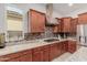 Well-appointed kitchen with stainless hood and granite counters with tile backsplash at 3816 E Rakestraw Ln, Gilbert, AZ 85298