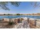 Scenic lake view from the community area, featuring a walkway and lush landscaping at 3816 E Rakestraw Ln, Gilbert, AZ 85298