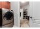 Laundry room featuring a modern washer and walk in storage with built in shelves at 3816 E Rakestraw Ln, Gilbert, AZ 85298