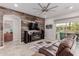 Spacious living room featuring a decorative wood wall, stylish furniture, and a ceiling fan at 3816 E Rakestraw Ln, Gilbert, AZ 85298