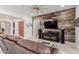 Spacious living room with a rustic wood wall and a comfortable leather sofa at 3816 E Rakestraw Ln, Gilbert, AZ 85298