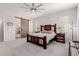 Bright main bedroom featuring a decorative wood bed frame and en suite access at 3816 E Rakestraw Ln, Gilbert, AZ 85298
