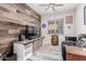 Stylish office with unique rustic wood wall, desk, comfortable seating, and window at 3816 E Rakestraw Ln, Gilbert, AZ 85298