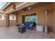 Inviting covered patio with comfortable seating and a ceiling fan for outdoor relaxation at 3816 E Rakestraw Ln, Gilbert, AZ 85298