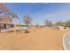 Community playground featuring swings, climbing structures, and a soft landing surface, set against a blue sky at 3816 E Rakestraw Ln, Gilbert, AZ 85298