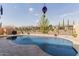 Sparkling private pool surrounded by desert landscaping and secured fencing for privacy at 3816 E Rakestraw Ln, Gilbert, AZ 85298