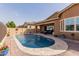 Stunning backyard oasis with a sparkling pool, lush plants, and outdoor seating at 3816 E Rakestraw Ln, Gilbert, AZ 85298