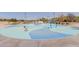 Community splash pad with colorful water features and a smooth, blue-patterned surface for children to enjoy at 3816 E Rakestraw Ln, Gilbert, AZ 85298