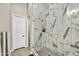 Modern walk-in shower with white marble tiling and sleek glass door, showcasing contemporary design at 38500 N School House Rd # 7, Cave Creek, AZ 85331