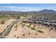 Expansive aerial view of a desert community with golf course, mountain views and single Gathering homes at 3948 E Vallejo Dr, Gilbert, AZ 85298
