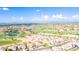 Scenic aerial view of a golf course community with houses and mountain views in the distance at 3948 E Vallejo Dr, Gilbert, AZ 85298