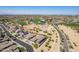 This aerial view displays the neighborhood, golf course, mature trees, and sparkling water at 3948 E Vallejo Dr, Gilbert, AZ 85298