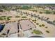 Expansive aerial view of a desert property adjacent to a lush golf course offering serene views at 3948 E Vallejo Dr, Gilbert, AZ 85298