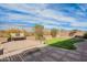 Lush backyard featuring a putting green alongside a brick patio and comfortable bench seating at 3948 E Vallejo Dr, Gilbert, AZ 85298
