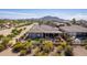 Aerial view of a fenced backyard with a covered patio, desert landscaping and desert views at 3948 E Vallejo Dr, Gilbert, AZ 85298