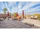 Spacious patio with a cozy fire pit, comfortable seating, and shade umbrellas for outdoor relaxation at 3948 E Vallejo Dr, Gilbert, AZ 85298