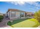 Back exterior featuring an artificial putting green, a covered patio, and low-maintenance landscaping at 3948 E Vallejo Dr, Gilbert, AZ 85298