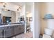 Well-lit bathroom with dual vanities, wood-look flooring, and a separate makeup area, optimizing space and style at 3948 E Vallejo Dr, Gilbert, AZ 85298