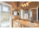 Well-appointed bathroom with double sinks and a walk-in shower for a luxurious experience at 3948 E Vallejo Dr, Gilbert, AZ 85298