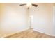 Empty bedroom featuring wood-look flooring, neutral paint and a white door to the hall at 3948 E Vallejo Dr, Gilbert, AZ 85298