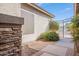 Charming walkway and gate with decorative rock and a pop of green landscaping at 3948 E Vallejo Dr, Gilbert, AZ 85298