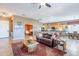 This living room has an open layout, wood-look tile, and views of the kitchen and office at 3948 E Vallejo Dr, Gilbert, AZ 85298
