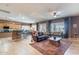 Open concept living area features wood-look tile, ceiling fans, and large windows at 3948 E Vallejo Dr, Gilbert, AZ 85298