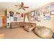 Cozy living room featuring a sectional sofa, ceiling fan, and sports-themed decor at 3948 E Vallejo Dr, Gilbert, AZ 85298